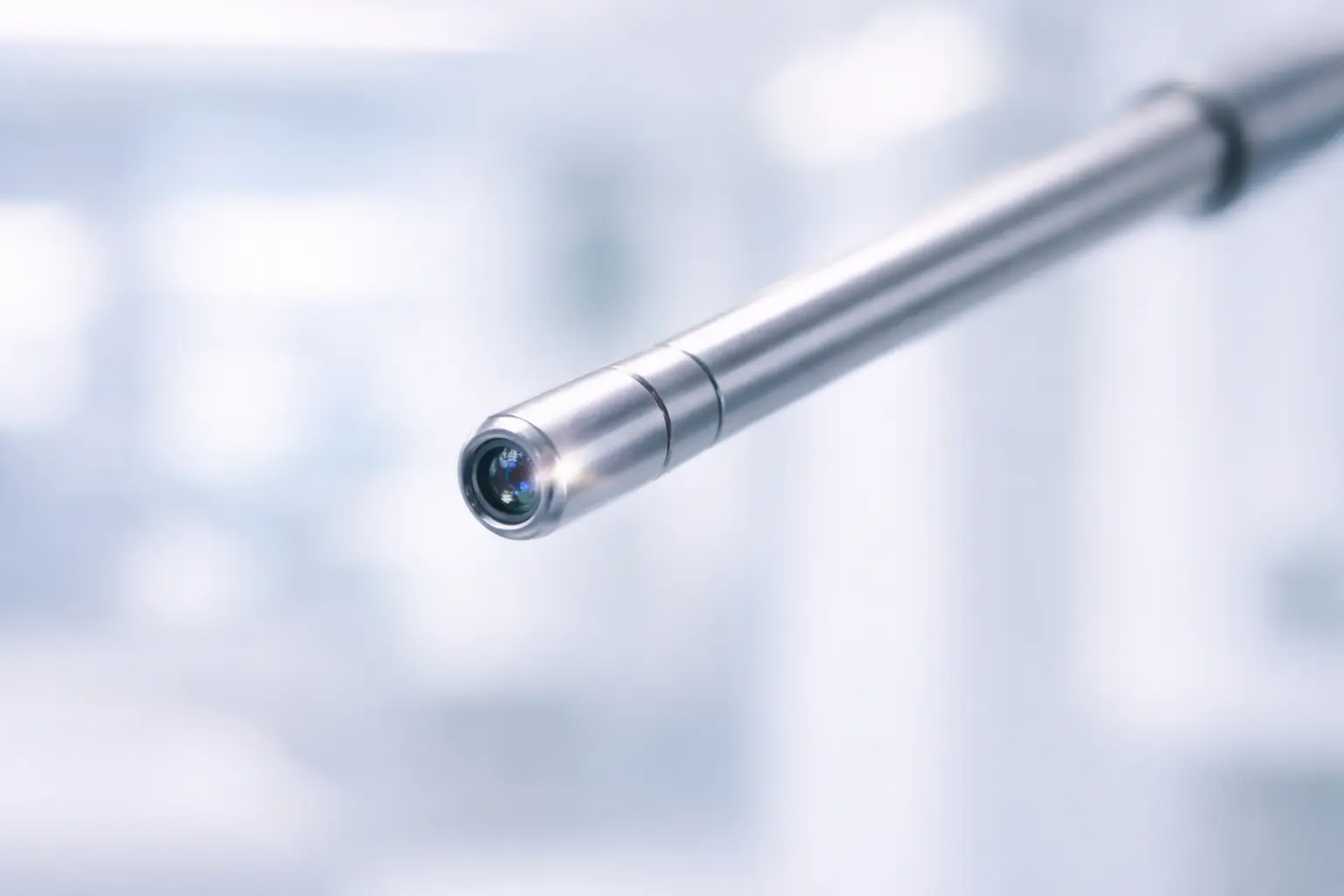 Close-up of the tip of a professional hysteroscope instrument, highlighting the camera lens used for internal uterine procedures