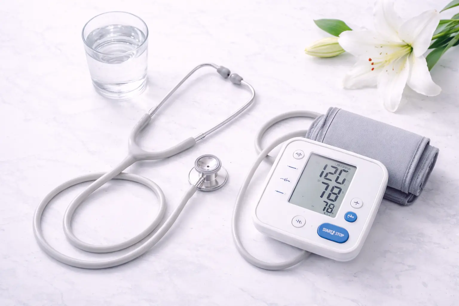 A minimalist medical arrangement including a stethoscope and blood pressure monitor, representing a thorough well-woman health check